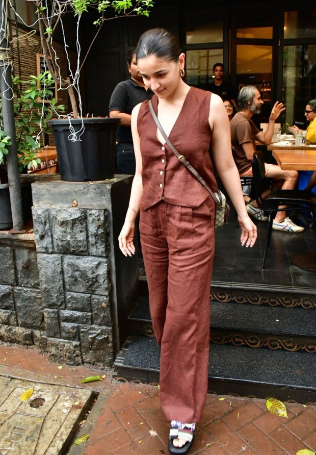 Alia Bhatt perfects the relaxed elegant look with casual brown pants and a waistcoat, together with a Gucci bag costing Rs. 1.35 lakh