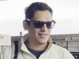 Vijay Varma smiles as he poses for paps at the airport