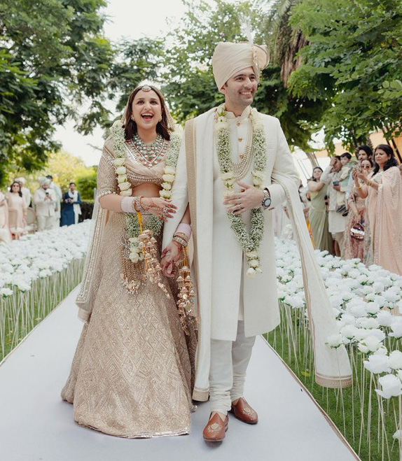Parineeti Chopra and Raghav Chadda adorn pastel ensembles by Manish Malhotra and Pawan Sachdeva, creating a perfect wedding look