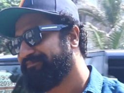 Vicky Kaushal poses with fans in a blue shirt & scruffy beard
