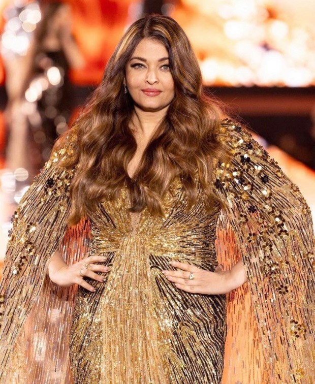 Aishwarya Rai Bachchan graces the Paris Fashion Week Ramp for L'Oréal in shimmery golden cape gown