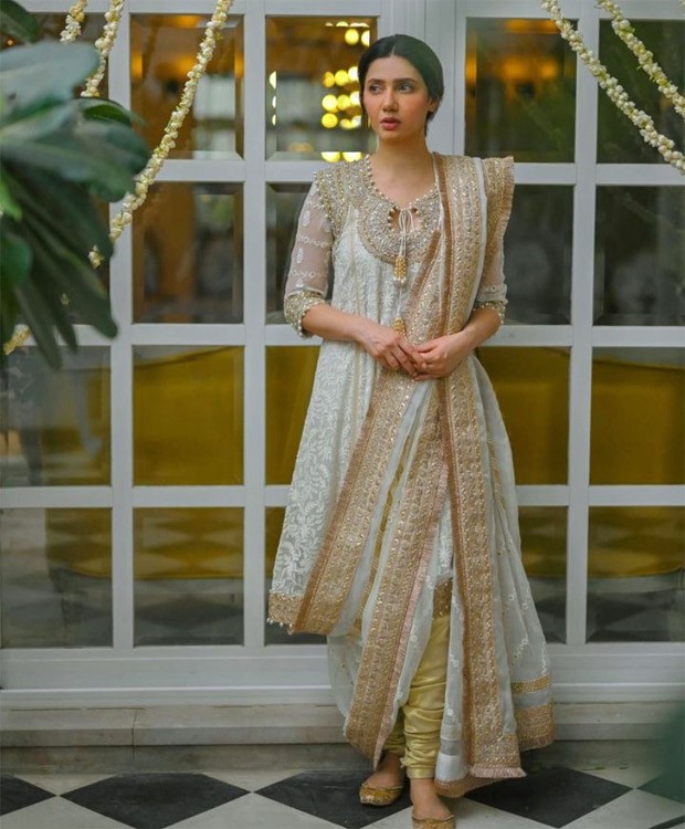 Mahira Khan beams with joy during her Mayoon ceremony, adorned in a vibrant orange Anarkali outfit