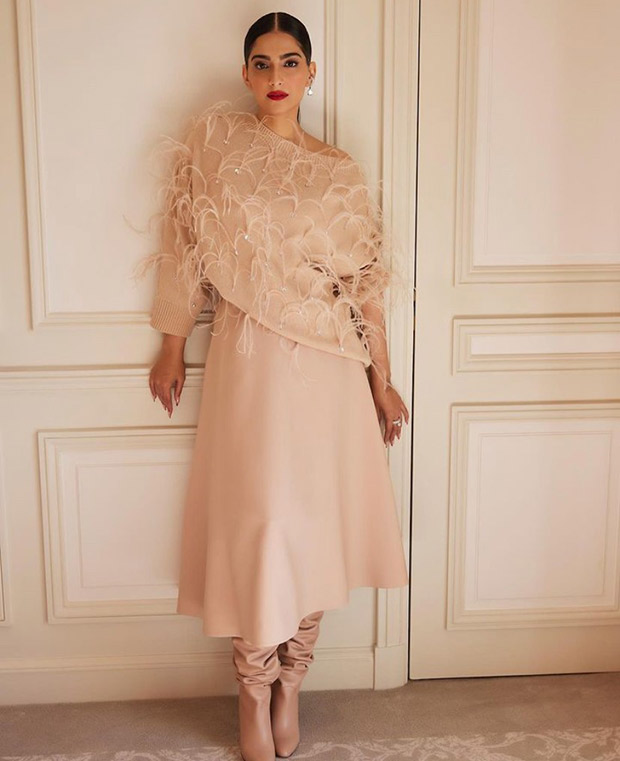 Sonam Kapoor captivates the audience at the Valentino Paris Fashion Week event in an off-shoulder cardigan, midi skirt, and stunning boots, stealing the spotlight effortlessly