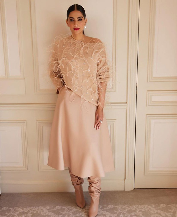 Sonam Kapoor captivates the audience at the Valentino Paris Fashion Week event in an off-shoulder cardigan, midi skirt, and stunning boots, stealing the spotlight effortlessly