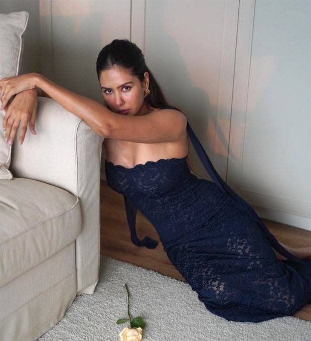 Sonam Bajwa stuns in a mesmerizing blue floral gown, complemented by a sleek scarf adorning her neck