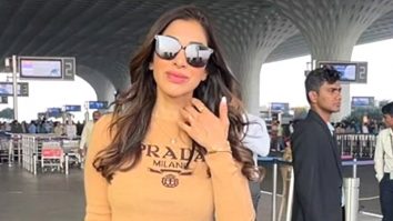 Sophie Choudry smiles for paps at the airport