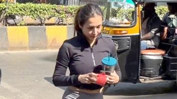 Malaika Arora poses with a little fan as she gets clicked outside gym