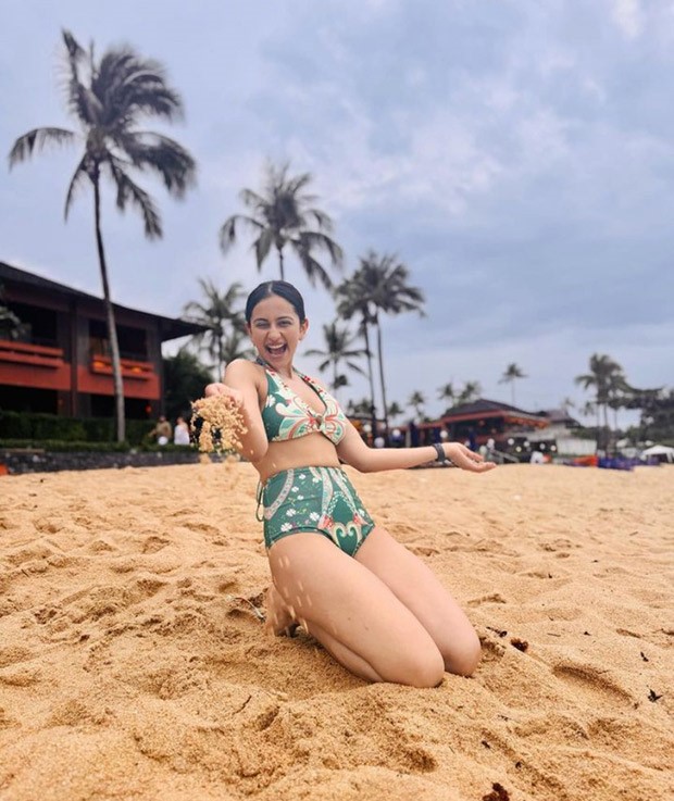 Rakul Preet Singh adorned in a green swim set, demonstrates unparalleled beach day style