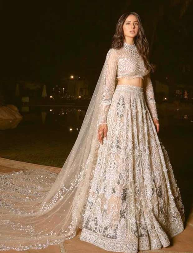 Rakul Preet Singh shines in a silver Falguni & Shane Peacock lehenga as Jackky Bhagnani lifts her in his arms during sangeet ceremony