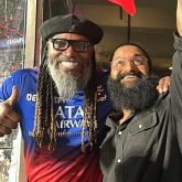 Rishab Shetty poses with Chris Gayle during RCB vs CSK match