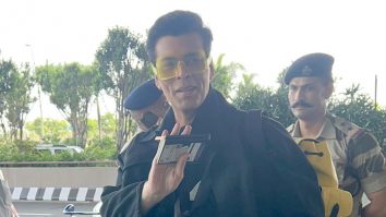 Karan Johar poses with Karisma Kapoor at the airport