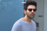 Kartik Aaryan poses with a fan as he gets clicked in the city