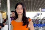 Vedhika rocks an orange crop top as she gets clicked at the airport