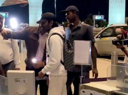 Dhanush poses for a selfie with fans at the airport