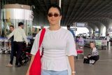 Sanya Malhotra greets paps with a smile at the airport